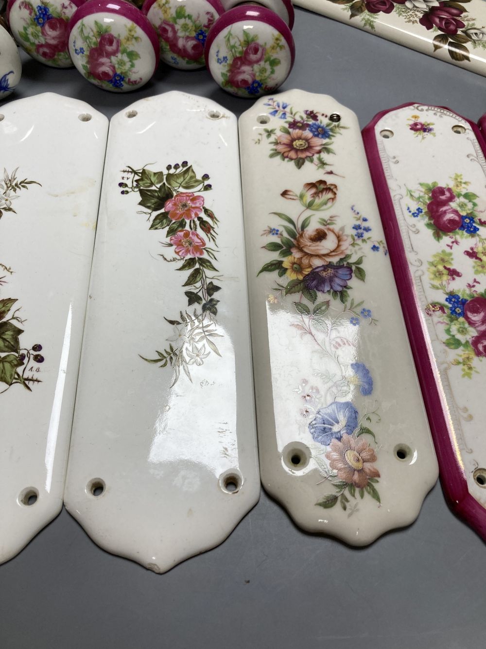Five pairs of French porcelain door handles and ten porcelain door plates